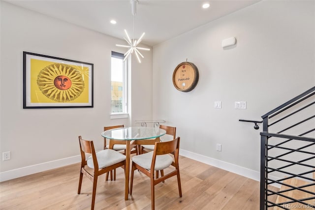 dining area featuring a notable chandelier and light hardwood / wood-style floors