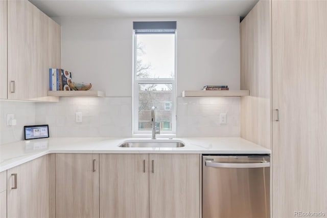 kitchen with sink, dishwasher, and light brown cabinets