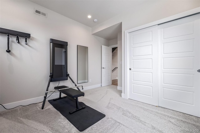 exercise room with light carpet