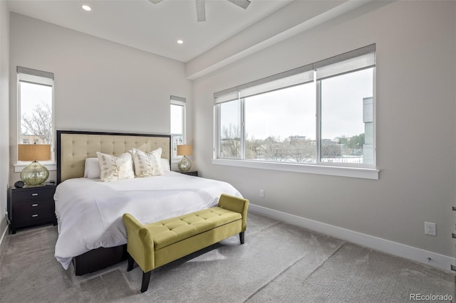 carpeted bedroom with multiple windows and ceiling fan