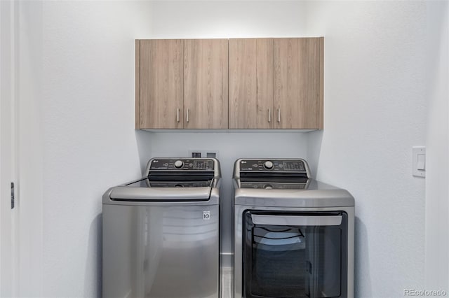 laundry area with cabinets and washer and dryer