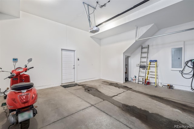 garage with a garage door opener and electric panel