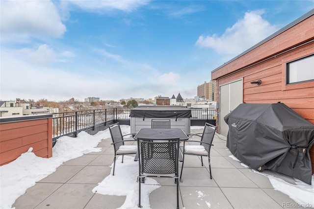 view of patio / terrace with area for grilling and a hot tub