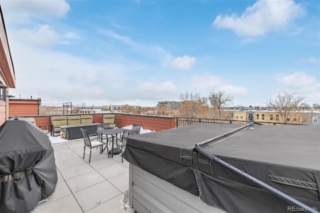 view of patio / terrace with a grill and a hot tub