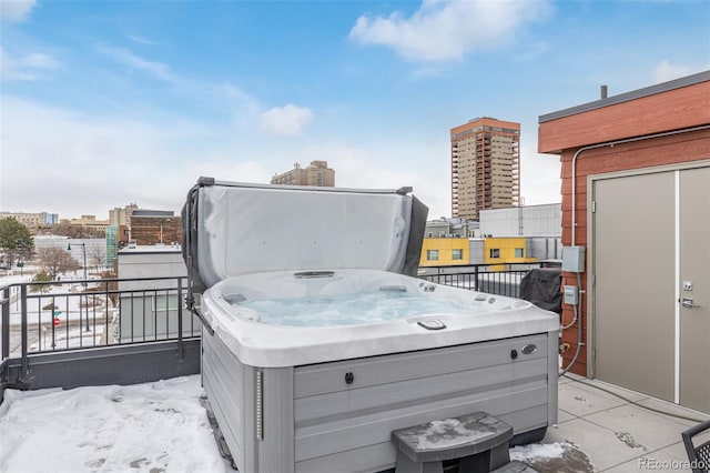 yard layered in snow with a hot tub