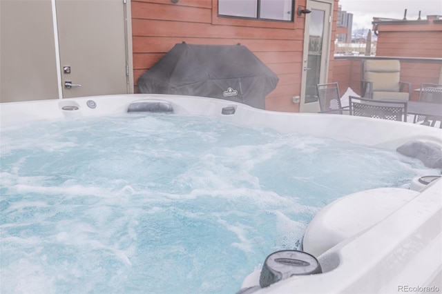 view of patio / terrace with a hot tub