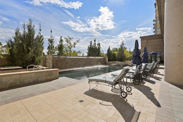 view of swimming pool with a patio