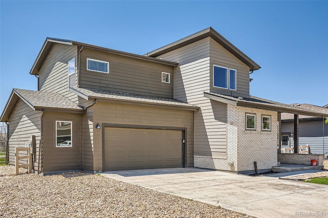 7263 Horsechestnut St, Wellington, CO 80549 - view of front of home with an attached garage, brick siding, concrete driveway, and roof with shingles