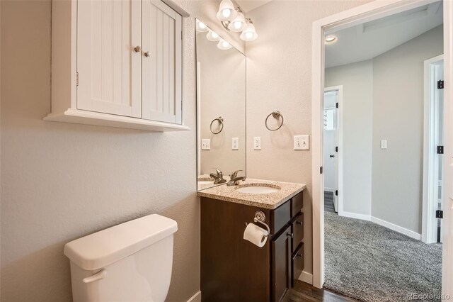 7263 Horsechestnut St, Wellington, CO 80549 - half bath with vanity, toilet, and baseboards
