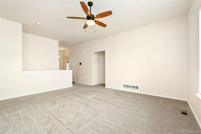 unfurnished room featuring carpet floors, visible vents, ceiling fan, and baseboards