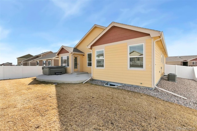 back of property featuring a fenced backyard, a patio, and central AC unit