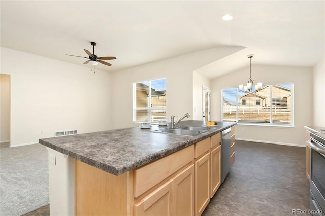 kitchen featuring stainless steel appliances, dark countertops, a sink, and visible vents