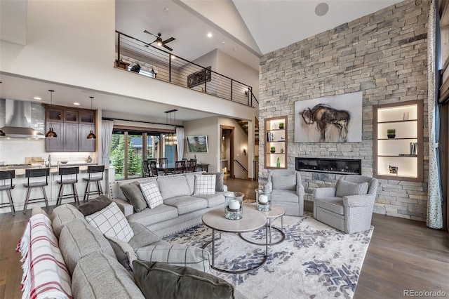 60 Barton Ridge Dr, Breckenridge, CO 80424 - living area with high vaulted ceiling, dark wood-type flooring, a fireplace, built in shelves, and recessed lighting