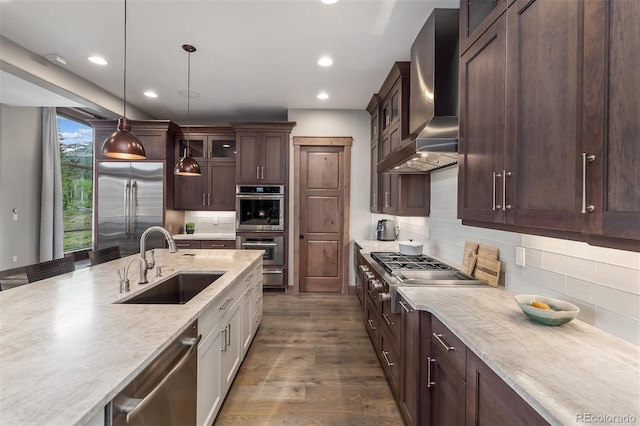 60 Barton Ridge Dr, Breckenridge, CO 80424 - kitchen featuring wall chimney exhaust hood, appliances with stainless steel finishes, glass insert cabinets, recessed lighting, and dark brown cabinetry
