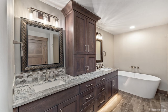 60 Barton Ridge Dr, Breckenridge, CO 80424 - full bathroom featuring a freestanding bath, double vanity, and wood finished floors