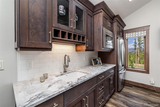 60 Barton Ridge Dr, Breckenridge, CO 80424 - kitchen with stainless steel microwave, dark brown cabinets, decorative backsplash, and lofted ceiling