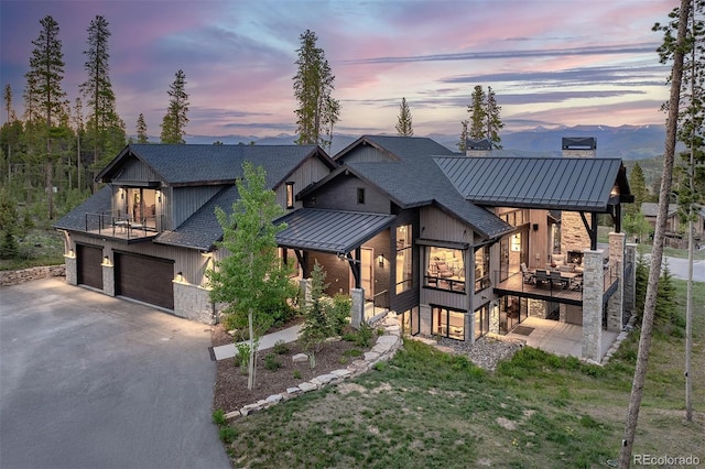 60 Barton Ridge Dr, Breckenridge, CO 80424 - view of front of house featuring roof with shingles, driveway, a standing seam roof, a balcony, and a metal roof