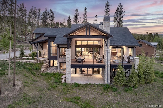 60 Barton Ridge Dr, Breckenridge, CO 80424 - rear view of property with roof with shingles, a chimney, and a wooden deck