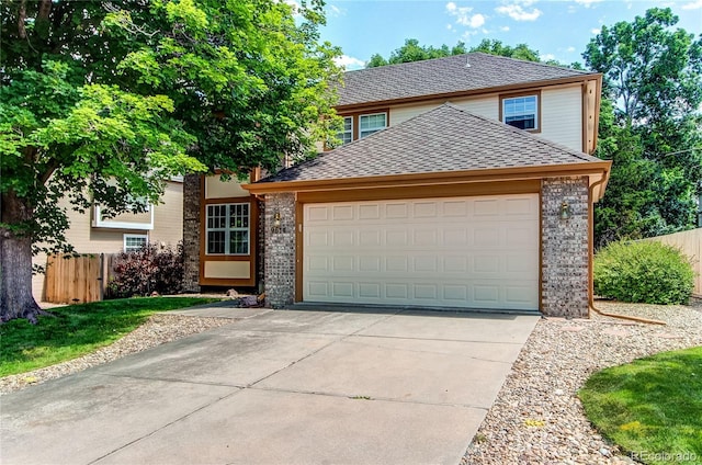9614 W Powers Cir, Littleton, CO 80123 - traditional-style house with an attached garage, brick siding, concrete driveway, and a shingled roof