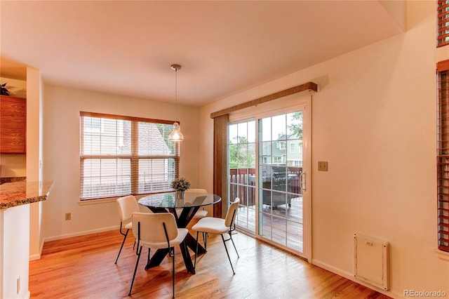 9614 W Powers Cir, Littleton, CO 80123 - dining area with light wood-style flooring and baseboards
