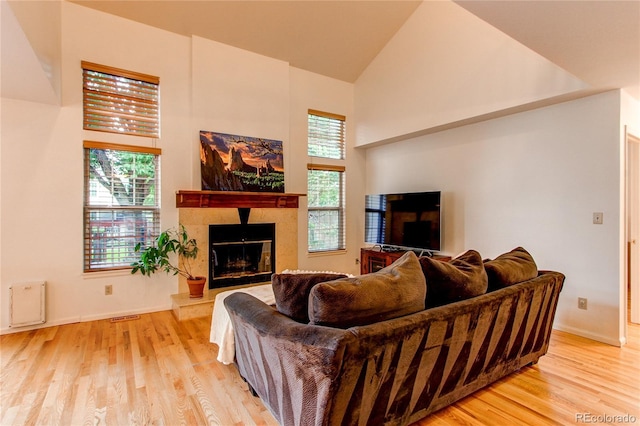 9614 W Powers Cir, Littleton, CO 80123 - living area with high vaulted ceiling, healthy amount of natural light, a high end fireplace, and light wood-style floors
