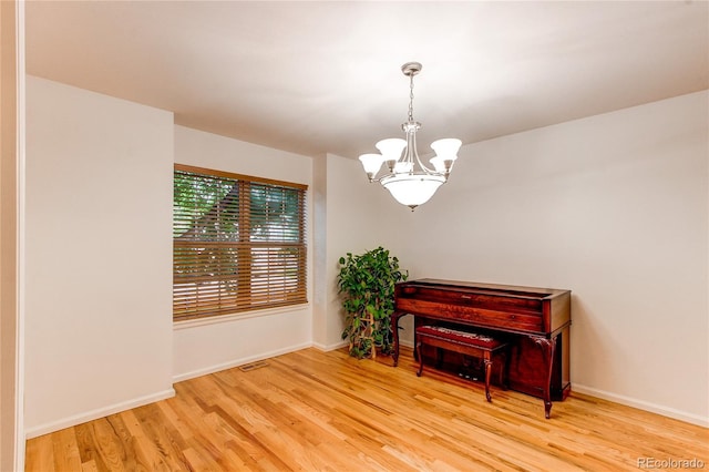 9614 W Powers Cir, Littleton, CO 80123 - sitting room featuring a chandelier and wood finished floors