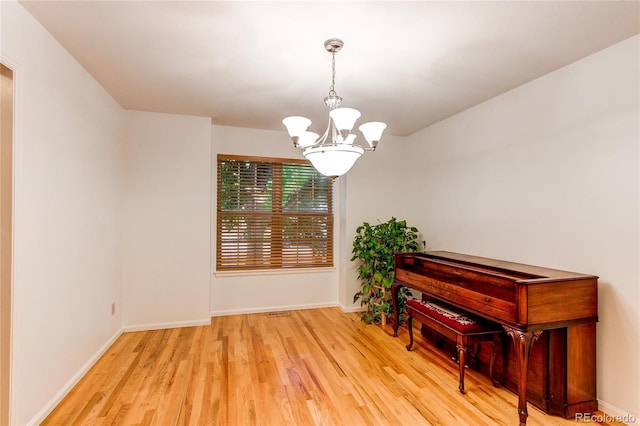9614 W Powers Cir, Littleton, CO 80123 - empty room with a chandelier and light wood-style flooring
