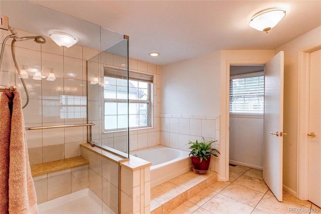 9614 W Powers Cir, Littleton, CO 80123 - bathroom featuring plenty of natural light, a stall shower, a bath, tile patterned floors, and recessed lighting