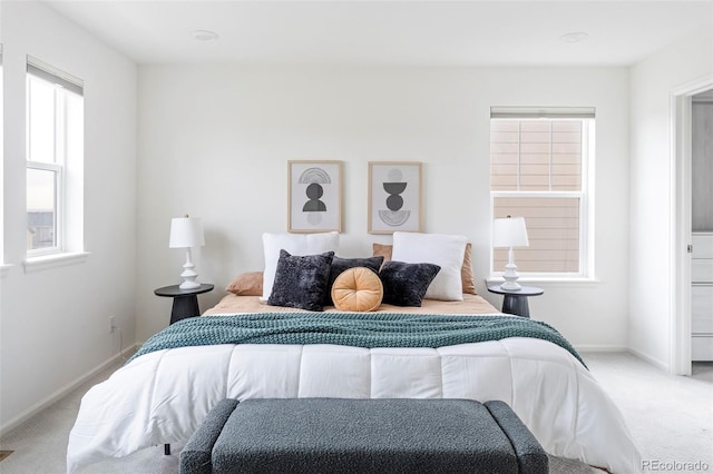 carpeted bedroom featuring baseboards
