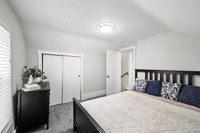 800 S Krameria St, Denver, CO 80224 - carpeted bedroom featuring vaulted ceiling, a closet, and a textured ceiling