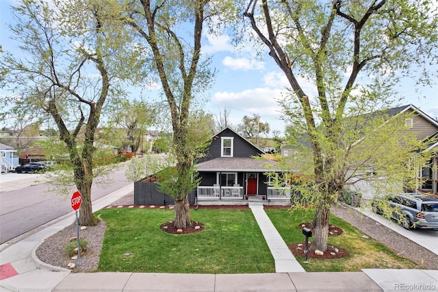 800 S Krameria St, Denver, CO 80224 - bungalow with a porch, a front yard, and roof with shingles
