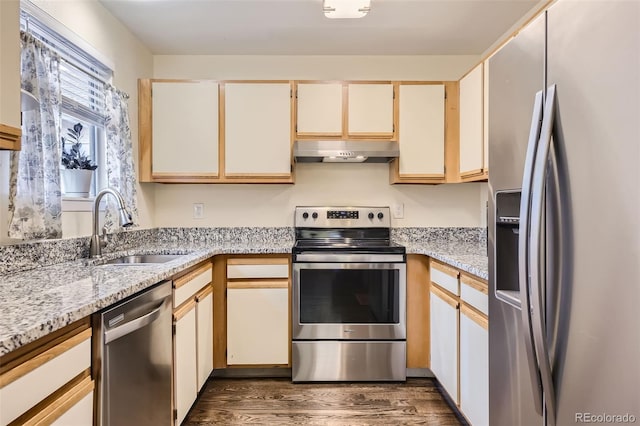 kitchen with light stone counters, sink, dark hardwood / wood-style floors, and appliances with stainless steel finishes