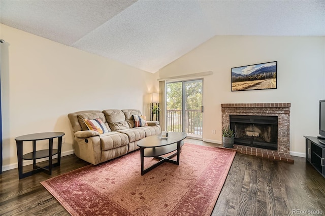 living room with dark wood-type flooring, a textured ceiling, lofted ceiling, and a fireplace