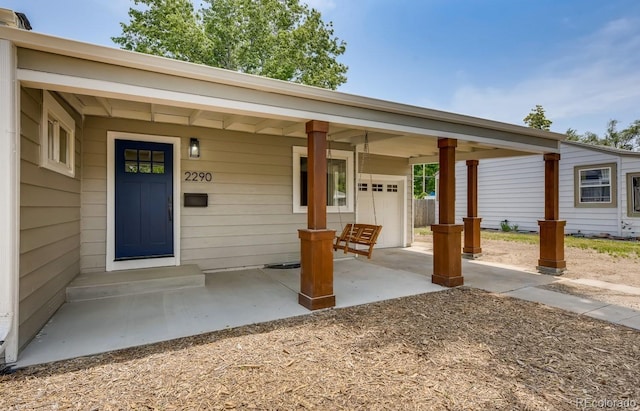 view of exterior entry featuring a porch