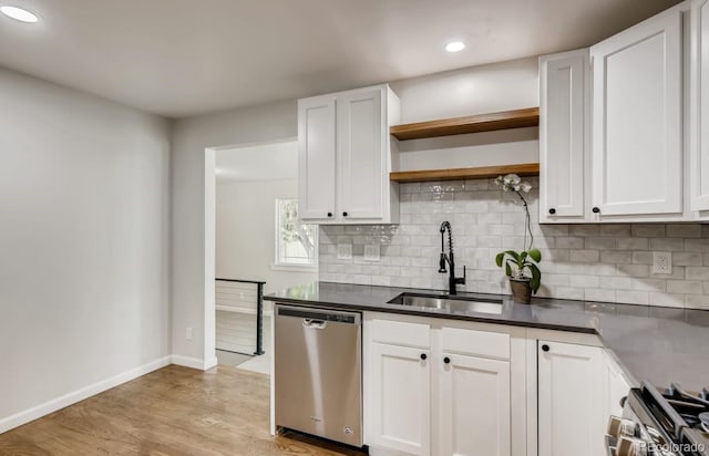 kitchen with dishwasher, range, sink, light hardwood / wood-style flooring, and white cabinetry