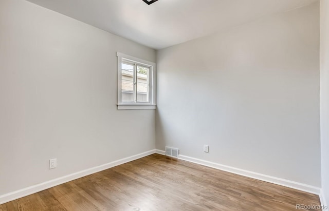 spare room featuring hardwood / wood-style flooring