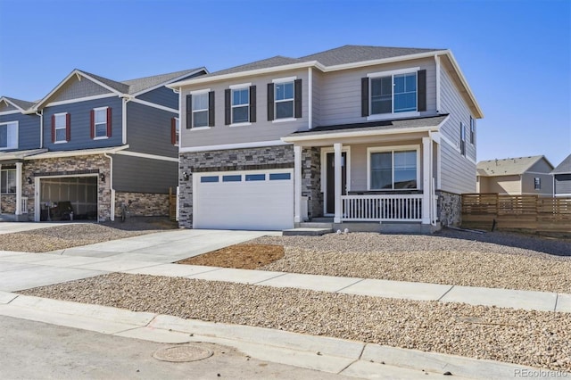 view of front of property featuring driveway, stone siding, an attached garage, fence, and a porch