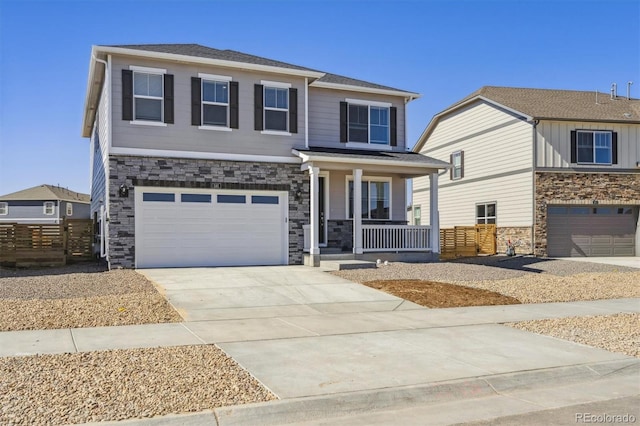 view of front of house featuring a porch, concrete driveway, stone siding, and a garage