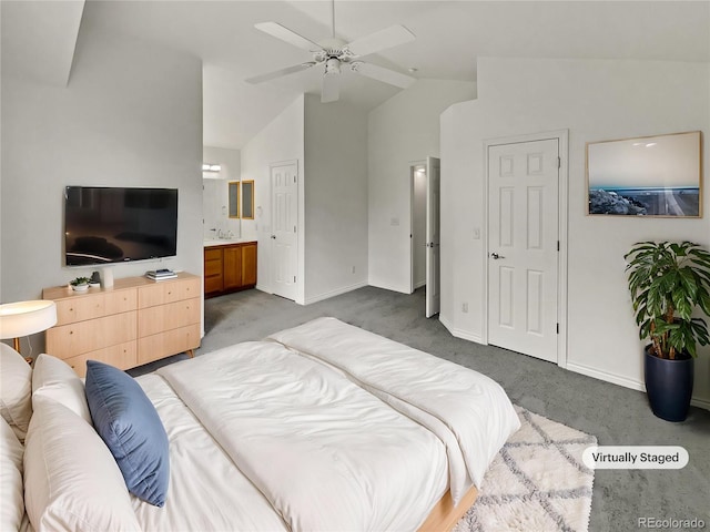 bedroom with vaulted ceiling, carpet floors, baseboards, ensuite bath, and a ceiling fan