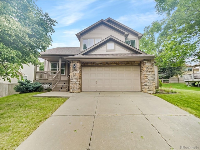 view of front of house featuring a front yard, stone siding, covered porch, and concrete driveway