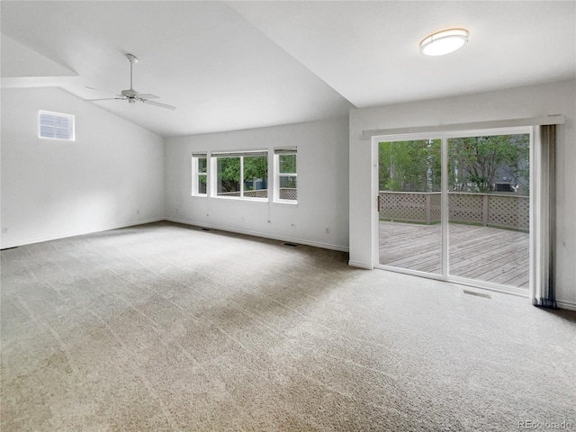 carpeted empty room featuring a ceiling fan, baseboards, and vaulted ceiling
