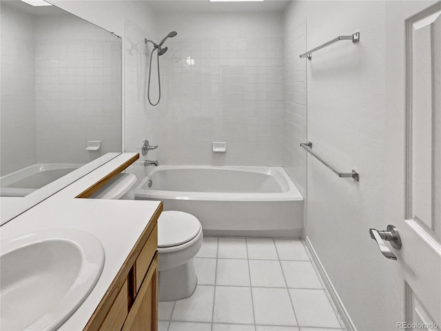 bathroom featuring toilet, tile patterned floors, vanity, baseboards, and bathing tub / shower combination