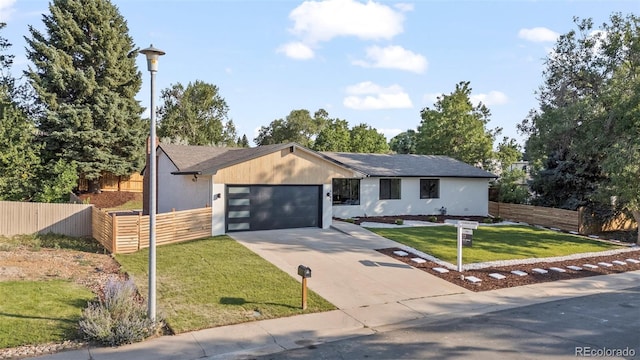 view of front of property featuring a garage and a front yard