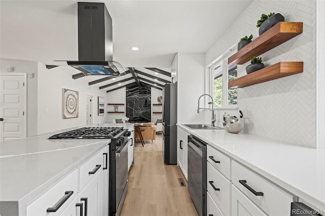 kitchen featuring white cabinetry, dishwasher, sink, gas range, and wall chimney exhaust hood