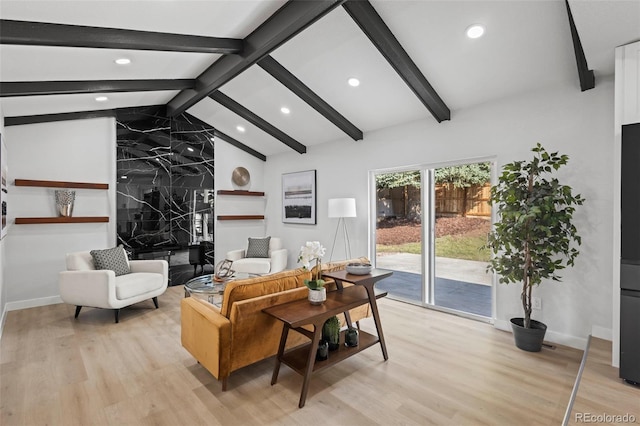 living room featuring lofted ceiling with beams and light wood-type flooring