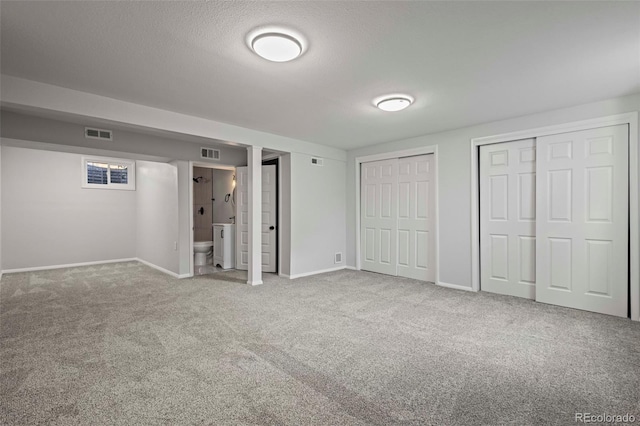 basement featuring carpet floors and a textured ceiling