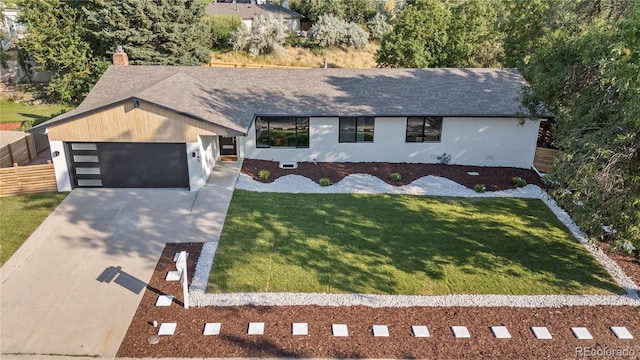 view of front of home with a garage and a front lawn