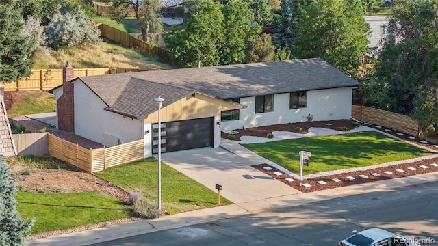 view of front of house with a garage and a front lawn