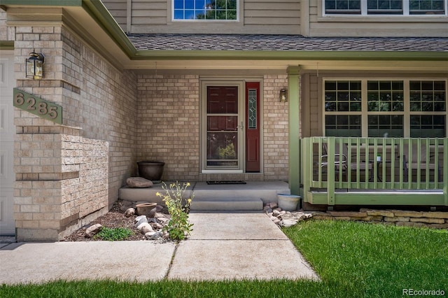 6285 Moccasin Pass Ct, Colorado Springs, CO 80919 - doorway to property with a porch, a shingled roof, and brick siding