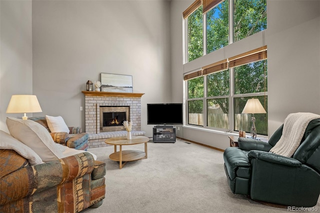 6285 Moccasin Pass Ct, Colorado Springs, CO 80919 - carpeted living room with a towering ceiling, healthy amount of natural light, and a brick fireplace